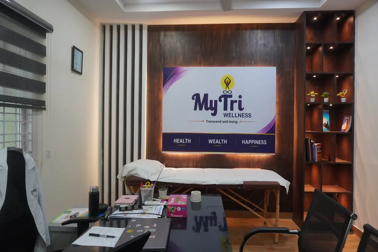 A counselling room at MyTri Wellness, Kukatpally, with the MyTri sign on a wood-panelled wall